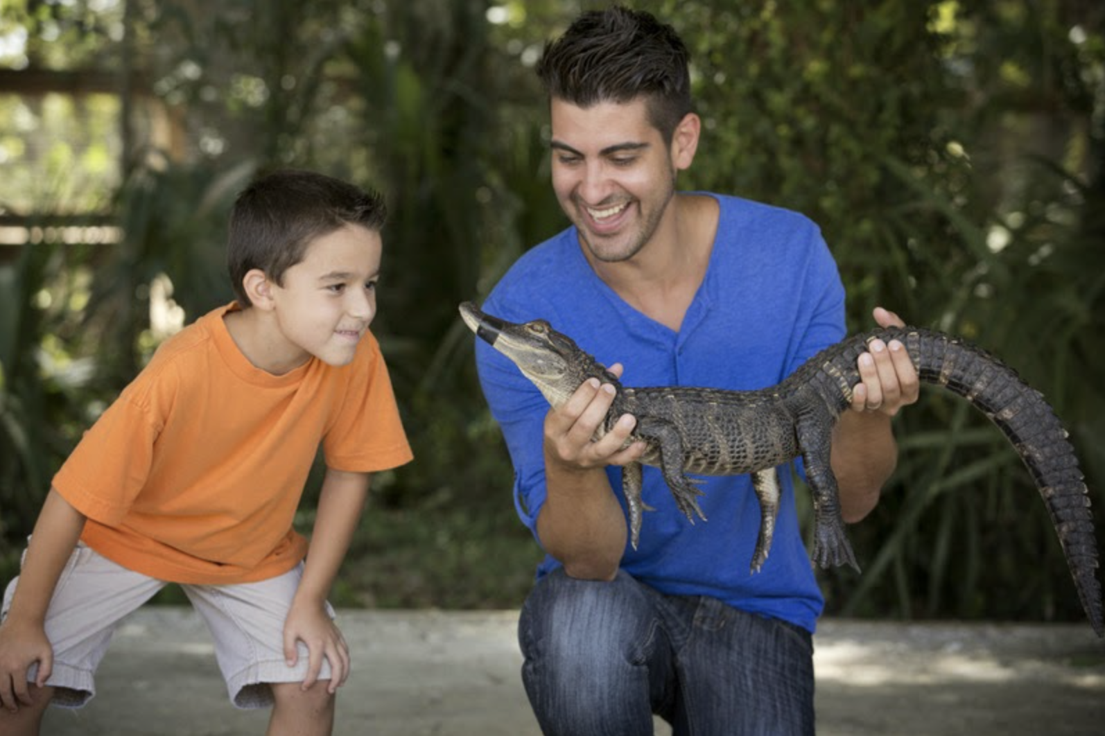 man holding small gator